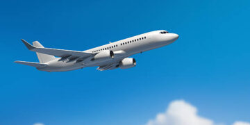 Passanger airplane flying above clouds.