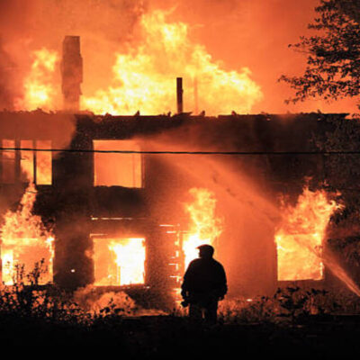 two silhouette on housefire background