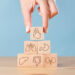 Hand arranging wood block stacking with icon internal organs