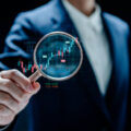 Businesswomen magnifier glass to find stock in stock markets, uptrends, growth economics, business strategy development, and investment opportunities, Investment Management Company, Financial Analyst.