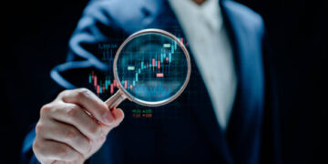 Businesswomen magnifier glass to find stock in stock markets, uptrends, growth economics, business strategy development, and investment opportunities, Investment Management Company, Financial Analyst.