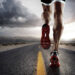 low angle view of male runners legs running down road wearing trainers