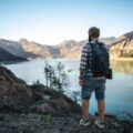 Hiking in the mountains. Tourist exploring lake in mountains