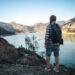 Hiking in the mountains. Tourist exploring lake in mountains