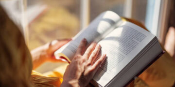 Teenage girl enjoying reading a book on windowsill. Sunny summer day.
Shot with Canon R5