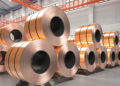 3d rendering roll of copper sheets or heap of copper tapes in factory