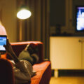 Young woman relaxing with smartphone on sofa