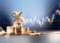 Percentage sign on top of coin stacks before blue financial graph. Horizontal composition with copy space. Business and finance concept.