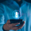 Voice recording. Man touching microphone icon on smart phone. Mobile application Record sound, audio, music, voice message. or Use your voice to direct AI to search for information on Internet.