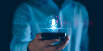 Voice recording. Man touching microphone icon on smart phone. Mobile application Record sound, audio, music, voice message. or Use your voice to direct AI to search for information on Internet.