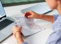 Woman In Office Managing Payroll Compensation Check Envelope With Care.